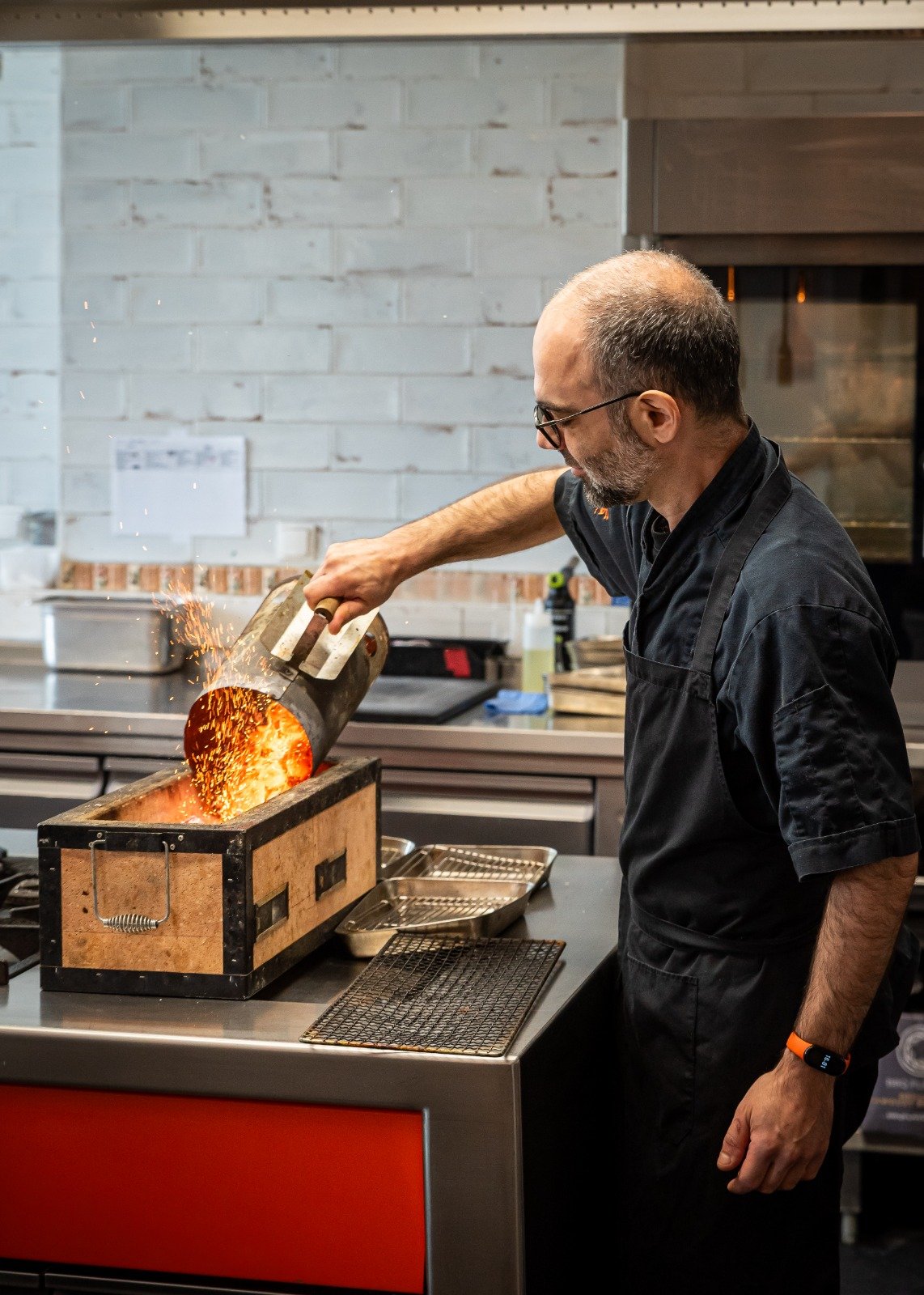 Chef pouring hot coals